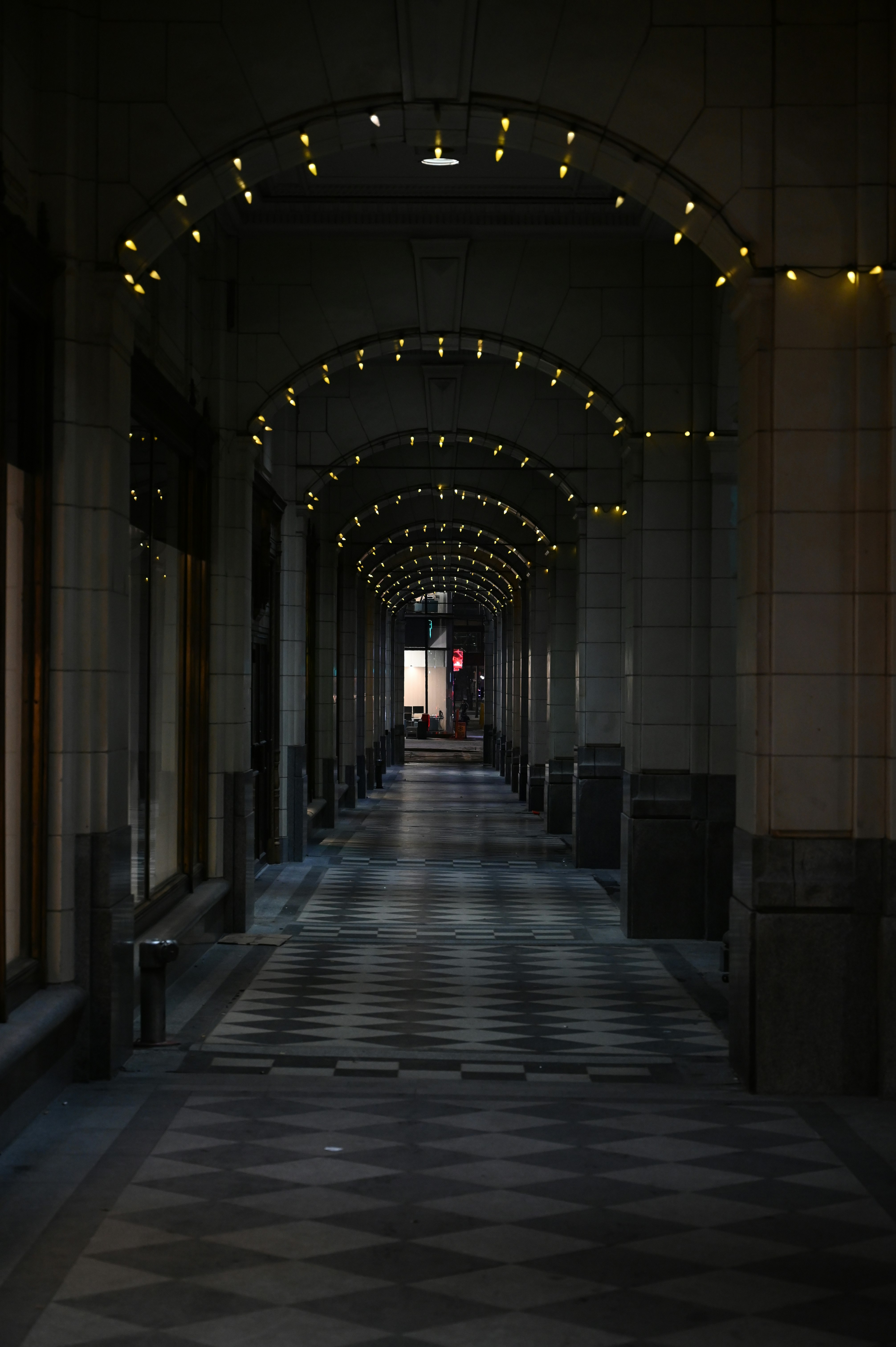 people walking on hallway with lights turned on during night time